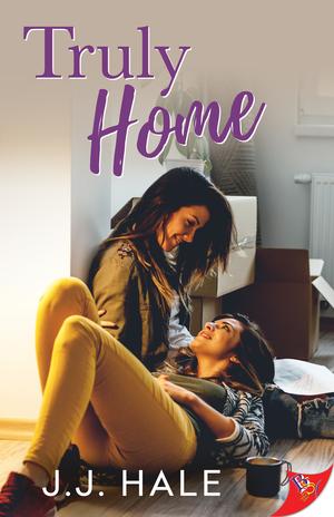Book cover for Truly Home, two women on the floor looking at each other lovingly, one lying in the others lap, moving boxes can be seen in the background. Title Truly Home is printed on the top of the cover and author J.J. Hale is printed on the bottom of the cover.