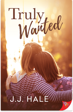 Book cover for Truly Wanted, two women leaning on each other with backs facing the cover front. Title Truly Wanted is printed on the top of the cover and author J.J. Hale is printed on the bottom of the cover. The cover colors are orange and yellow tones.